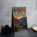 A vintage metal sign advertising the Gulf of Portugal, featuring a scenic landscape with mountains, a bay, and palm trees.
