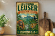 A vintage-style sign for Gunung Leuser Biosphere Reserve in Indonesia, featuring an illustration of an orangutan, tiger, and other wildlife in a lush, green forest setting.