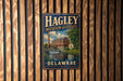 A vintage metal sign for the Hagley Museum and Estate in Delaware, featuring an illustration of a building and a river.