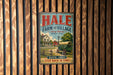 A vintage metal sign for Hale Farm and Village, featuring an illustration of a farm scene with a wagon and a house.