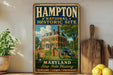 A vintage-style metal sign for the Hampton National Historic Site in Maryland, featuring an illustration of a historic house with a cannon in the foreground.