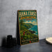 A vintage-style sign for the Hana Coast, Hawaii, featuring a tropical landscape with palm trees, mountains, and the ocean.