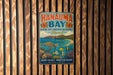 A vintage metal sign for Hanauqua Bay, Hawaii, featuring an illustration of a sea turtle swimming among colorful fish and coral.