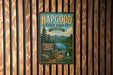 A vintage metal sign for Hapgood State Forest in Vermont, featuring a scenic illustration of a forest, a lake, and mountains.