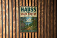 a vintage metal sign for the Haus State Forest in Alabama, with a scenic illustration of a forest and a lake.