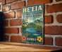 A vintage-style metal sign for the National Estuarine Research Reserve in Hawaii, featuring a tropical landscape with mountains, palm trees, and a body of water.