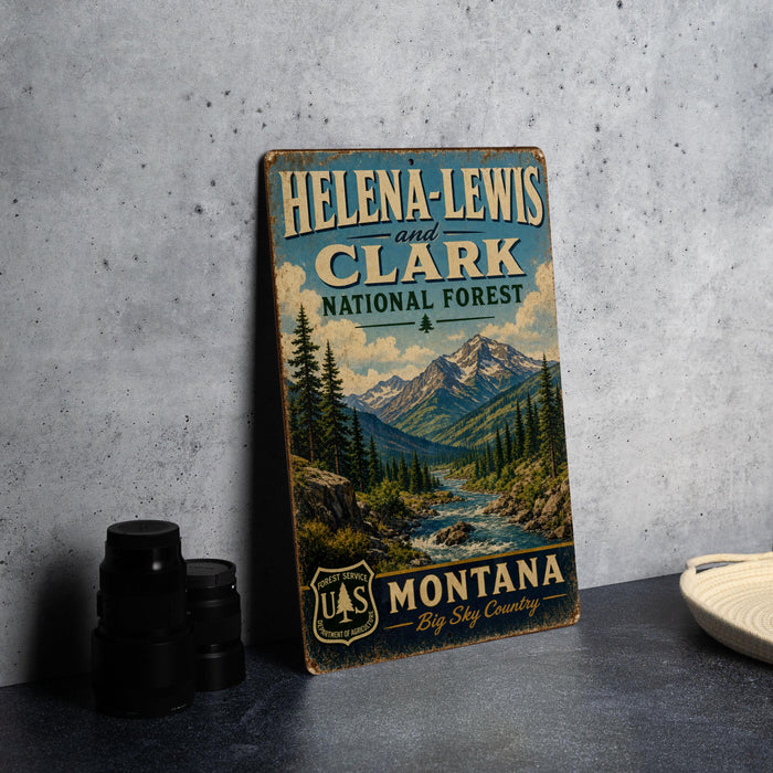 A vintage-style sign for Helena-Lewis and Clark National Forest in Montana, featuring a scenic mountain landscape.