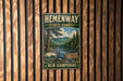 A vintage-style metal sign for Hemenway State Forest in New Hampshire, featuring a scenic image of a forest and a river.