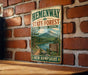 A vintage-style metal sign for Hemenway State Forest, featuring a scenic landscape with a mountain, lake, and forest.
