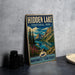 A vintage-style sign for Hidden Lake, a terrarium park in the Northwest Territories, featuring a scenic landscape with mountains, pine trees, and a lake.