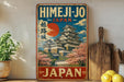 A vintage-style sign advertising Himeji-jo, Japan, featuring a castle and cherry blossoms.