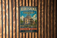 A vintage metal sign for the Hiroshima Peace Memorial, featuring an illustration of the Genbaku Dome, is displayed on a wooden wall.