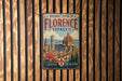 A vintage-style metal sign for the Historic Centre of Florence, Italy, featuring a colorful illustration of the city's landmarks and a message about the area being like no other.