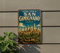 A vintage-style metal sign with the text "Historic Centre of San Gimignano Italy" and a picture of the city of San Gimignano, Italy, is displayed on a wall.