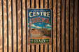 A vintage-style metal sign with the text "HISTORIC CENTRE of Siena Italy" displayed on a wooden wall.