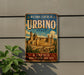 A vintage-style metal sign for the Historic Centre of Urbino, Italy, featuring an illustration of the historic city of Urbino.