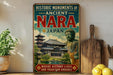 A vintage-style sign advertising the "Historic Monuments of Ancient Nara Japan" is displayed on a shelf, with a potted plant and wooden cutting board visible in the background.
