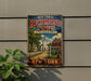 A vintage-style metal sign for Historic Richmond Town, featuring a scenic illustration of a small town with a church, houses, and a dirt road.