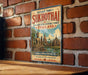 a vintage-style sign for the historic town of Sukhothai, Thailand, with a brick wall in the background.