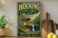 A vintage-style metal sign for Hocking State Forest in Ohio, featuring a scenic image of a waterfall surrounded by lush greenery.