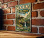 A vintage-style metal sign for Hocking State Forest in Ohio, featuring a scenic image of a waterfall and forest.
