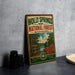 A vintage-style metal sign for the Holly Springs National Forest in Mississippi, featuring a scenic landscape with a lake, trees, and flowers.