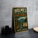 A vintage-style metal sign for Holmes State Forest, featuring a scenic illustration of a forest and mountains, is displayed on a gray concrete surface.