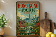 A vintage-style poster of Hong Kong Park, China, featuring a traditional Chinese pavilion and a modern city skyline, is displayed on a wall next to a wooden cutting board and a potted plant.