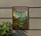 A vintage-style metal sign with the text "HONG KONG PARK CHINA" and a scenic illustration of the city of Hong Kong, featuring traditional Chinese architecture, a pagoda, and a bridge.