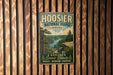 A vintage-style metal sign for Hoosier National Forest in Indiana, featuring a scenic landscape with a lake and mountains.