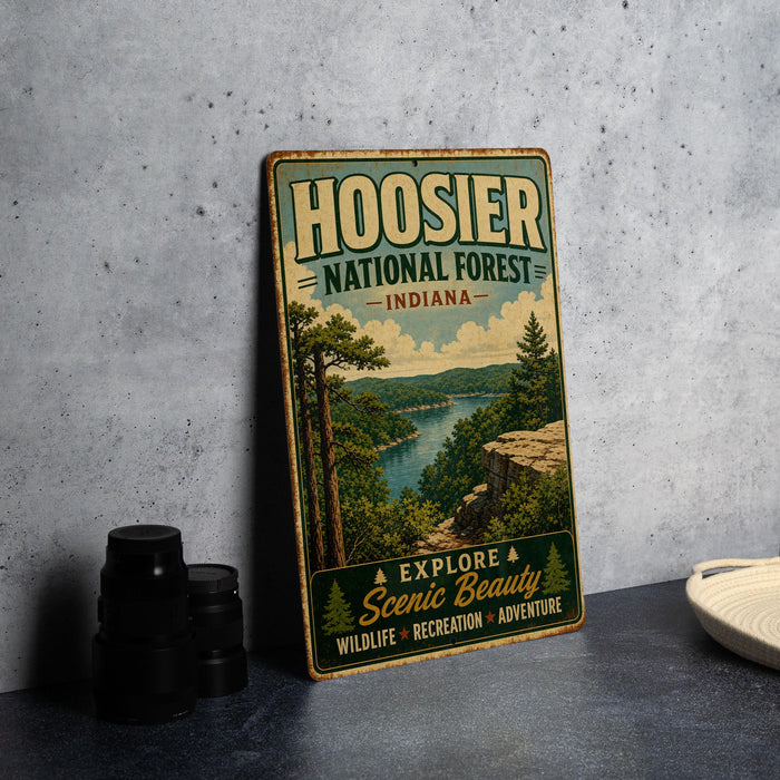A vintage-style metal sign for Hoosier National Forest in Indiana, featuring a scenic landscape with a river and forest.