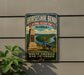 A vintage metal sign for Horseshoe Bend National Military Park in Alabama, featuring a cannon and a scenic landscape.