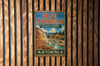 A vintage-style sign for Hot Springs State Park in Wyoming, featuring a scenic illustration of the park's natural beauty.