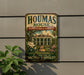 A vintage-style metal sign for the Housas House Plantation & Gardens, located in Louisiana, is displayed on a wall.