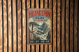 A vintage metal sign with the text "HUANGSHAN PARK CHINA" and a landscape image of mountains and trees, mounted on a wooden wall.