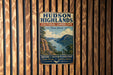 A vintage-style sign for Hudson Highlands Cultural Landscape, featuring a scenic mountain landscape with a river and a sailboat.