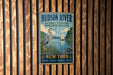 A vintage-style metal sign for the Hudson River National Estuarine Research Reserve, featuring an illustration of a crane and a sailboat on a body of water.