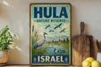 A vintage-style sign for the Hula Nature Reserve in Israel, featuring a bird illustration and a scenic landscape.