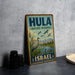 A vintage-style metal sign for the Hula Nature Reserve in Israel, featuring a bird illustration and text.