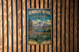 A vintage-style metal sign for Humboldt-Toiyabe National Forest, featuring a mountain landscape and text indicating the location.