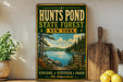 A vintage-style sign for "Hunts Pond State Forest New York" is displayed on a wooden shelf, with a potted plant and a wooden cutting board nearby.