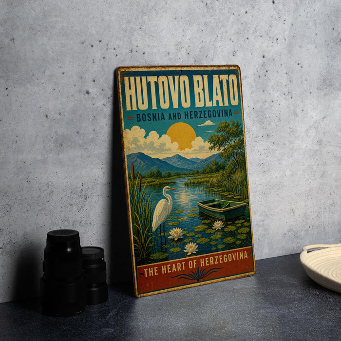 A vintage-style poster advertising Hutovo Blato, a city in Bosnia and Herzegovina, featuring a serene landscape with a lake, a boat, and a crane.