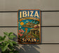 A vintage-style metal sign with the text "IBAZ" and "BIODIVERSITY & CULTURE" is displayed on a wall, featuring a tropical island landscape with palm trees, flowers, and a bird.