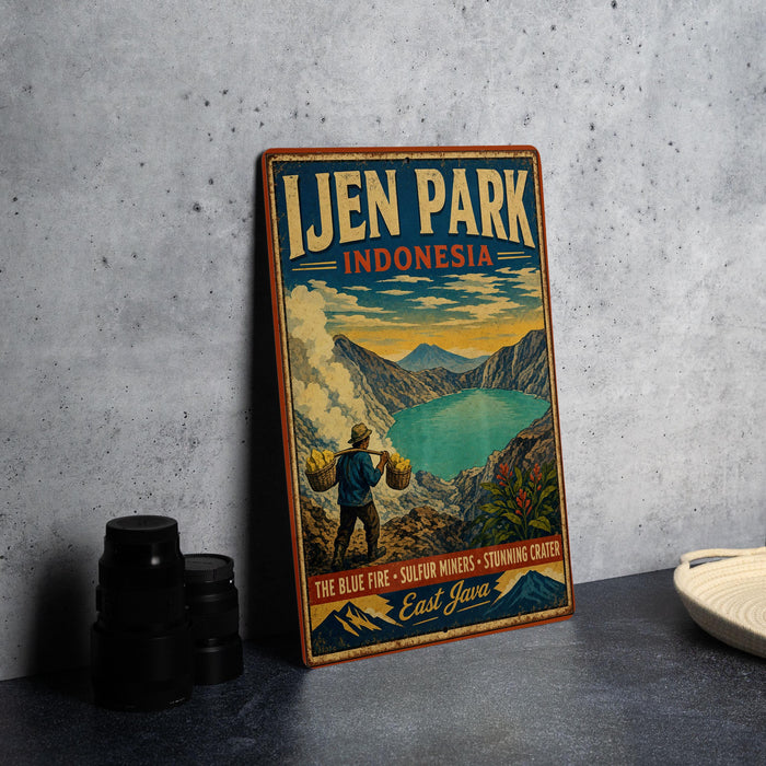 A vintage-style sign for Ijen Park, Indonesia, featuring a man carrying a basket and a scenic landscape with mountains and a lake.
