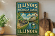A vintage-style sign for the Illinois and Michigan Canal, featuring a horse-drawn carriage and a building, is displayed on a shelf next to a wooden cutting board and some lemons.