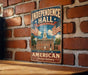 A vintage metal sign with the text "Independence Hall Philadelphia Pennsylvania" and an illustration of a building with a clock tower, mounted on a brick wall.