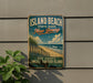 A vintage-style sign for Island Beach State Park in New Jersey, featuring a beach scene with palm trees and a fence, mounted on a wall.