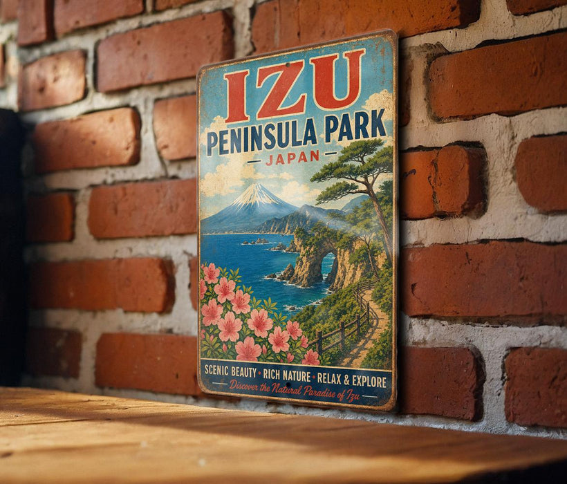 A vintage-style metal sign for Izu Peninsula Park in Japan, featuring a scenic landscape with mountains, a river, and a path leading through the natural setting.