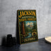 A vintage-style sign for Jackson State Forest in California, featuring a scenic illustration of a forest with a river and mountains.
