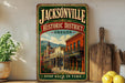 A vintage-style sign for the historic district of Jacksonville, Oregon, featuring an illustration of a historic building and mountain backdrop.